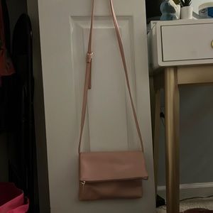 pink bag with long strap adjustable and 3 pockets one on the outside